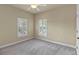 Bedroom featuring neutral walls, carpeted floor, ceiling fan and double shuttered windows at 5303 Brady Ln, Orlando, FL 32814