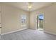 Bedroom featuring neutral walls, carpet, ceiling fan, shuttered window and access to balcony at 5303 Brady Ln, Orlando, FL 32814
