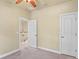 Open bedroom with ceiling fan with entry to staircase, and doorway to a closet at 5303 Brady Ln, Orlando, FL 32814