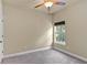 Bright bedroom with a ceiling fan, carpet floors, and a sunlit window at 5303 Brady Ln, Orlando, FL 32814