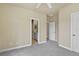 Bedroom with neutral walls, carpet, ceiling fan and multiple doorways including access to ensuite bathroom at 5303 Brady Ln, Orlando, FL 32814