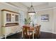 Cozy dining room features a wooden table, shuttered windows, and a charming display cabinet at 5303 Brady Ln, Orlando, FL 32814