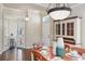 Open dining room with dark wood floors, table set for a meal, and adjacent office through french doors at 5303 Brady Ln, Orlando, FL 32814