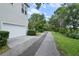 Long driveway leading to a home with an attached garage surrounded by greenery at 5303 Brady Ln, Orlando, FL 32814