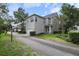 Lovely home exterior featuring a driveway, well-manicured lawn, and mature trees at 5303 Brady Ln, Orlando, FL 32814
