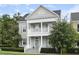Charming two-story home with a welcoming front porch, columns, blue shutters, and a well-maintained yard at 5303 Brady Ln, Orlando, FL 32814