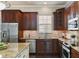 A close-up view of the kitchen, showcasing the stainless steel appliances and granite countertops at 5303 Brady Ln, Orlando, FL 32814