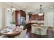 A well-appointed kitchen with an adjacent dining area, stainless steel appliances, and stylish lighting at 5303 Brady Ln, Orlando, FL 32814