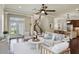 Spacious living room with white couches, an open staircase, kitchen view and access to the patio at 5303 Brady Ln, Orlando, FL 32814