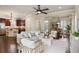 Open-concept living room showcasing dark wood floors, neutral furniture, and seamless flow into the kitchen at 5303 Brady Ln, Orlando, FL 32814