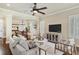 Bright living room with dark wood floors, neutral decor, with kitchen and dining areas visible at 5303 Brady Ln, Orlando, FL 32814