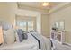 Bright main bedroom with stylish decor, a tray ceiling, and plenty of natural light at 5303 Brady Ln, Orlando, FL 32814