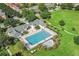 Aerial view of a community pool and recreation area surrounded by lush greenery and well-maintained lawns at 5303 Brady Ln, Orlando, FL 32814