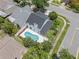 Aerial view of a home with a blue pool, white fence, and well-maintained landscaping in a residential neighborhood at 554 Queensbridge Dr, Lake Mary, FL 32746
