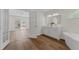Primary bathroom featuring a double sink vanity, wood look flooring, and a view to the bedroom at 554 Queensbridge Dr, Lake Mary, FL 32746
