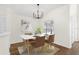 Bright dining room featuring a modern light fixture, updated furniture, and natural light at 554 Queensbridge Dr, Lake Mary, FL 32746