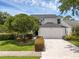 Charming two-story home with a well-manicured lawn, a large driveway, and attached two-car garage at 554 Queensbridge Dr, Lake Mary, FL 32746