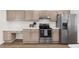 Spacious kitchen featuring stainless steel appliances and wooden cabinets with a breakfast bar at 554 Queensbridge Dr, Lake Mary, FL 32746