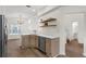 Kitchen with stainless steel appliances, wooden cabinets, and view to the dining room and pool area at 554 Queensbridge Dr, Lake Mary, FL 32746