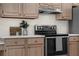 Modern kitchen with stainless steel appliances and light wood cabinets at 554 Queensbridge Dr, Lake Mary, FL 32746