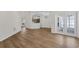 Open-concept living space with luxury vinyl plank flooring, access to the kitchen and a private patio at 554 Queensbridge Dr, Lake Mary, FL 32746