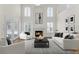 Bright living room with a fireplace, soaring ceilings, neutral color palette, and lots of natural light at 554 Queensbridge Dr, Lake Mary, FL 32746