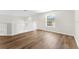 Bright loft featuring wood-look floors, a window, and white railing, creating a modern and airy space at 554 Queensbridge Dr, Lake Mary, FL 32746