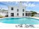 Relaxing backyard featuring a sparkling pool, screened-in patio, and white fencing for serene outdoor living at 554 Queensbridge Dr, Lake Mary, FL 32746