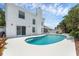 A beautiful backyard featuring a pool, chairs, and tropical landscaping at 554 Queensbridge Dr, Lake Mary, FL 32746
