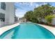 Backyard featuring a pool, white fence and some tropical plants at 554 Queensbridge Dr, Lake Mary, FL 32746