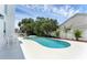 A backyard featuring a Kidney bean-shaped pool with some tropical plants and furniture at 554 Queensbridge Dr, Lake Mary, FL 32746