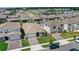 An aerial scene featuring neatly arranged homes with manicured lawns in a picturesque lakeside community at 5641 Oak Knoll Dr, St Cloud, FL 34771