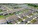 Beautiful aerial view showcasing a well-planned community with a lake and lush green spaces at 5641 Oak Knoll Dr, St Cloud, FL 34771