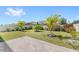 Spacious backyard featuring lush green grass, tropical landscaping, and a brick paver patio perfect for outdoor entertaining at 5641 Oak Knoll Dr, St Cloud, FL 34771