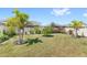 Expansive backyard with vibrant landscaping, lush grass, and a privacy fence, creating a serene outdoor retreat at 5641 Oak Knoll Dr, St Cloud, FL 34771