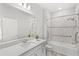 Bathroom featuring a wide mirror, shower with handrails, and a bathtub with tiled walls at 5641 Oak Knoll Dr, St Cloud, FL 34771