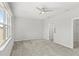 Spacious bedroom with carpet flooring, a ceiling fan, and a large window for natural light at 5641 Oak Knoll Dr, St Cloud, FL 34771