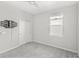 A gray carpeted bedroom with a ceiling fan, a closet and a wall-mounted tv bracket at 5641 Oak Knoll Dr, St Cloud, FL 34771