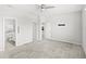 A large bedroom offers ensuite bathroom access, walk-in closets, carpet, and a ceiling fan at 5641 Oak Knoll Dr, St Cloud, FL 34771