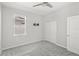 Well-lit bedroom with gray carpet, closet, ceiling fan, and a wall-mounted TV bracket at 5641 Oak Knoll Dr, St Cloud, FL 34771