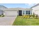 Beautiful home with manicured lawn, brick paved driveway and attached two car garage at 5641 Oak Knoll Dr, St Cloud, FL 34771