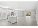 Bright open-concept kitchen and living area with tile floors and sliding glass doors to the backyard at 5641 Oak Knoll Dr, St Cloud, FL 34771