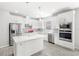 Modern kitchen with white cabinets, stainless steel appliances and kitchen island at 5641 Oak Knoll Dr, St Cloud, FL 34771
