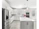 Modern kitchen with stainless steel appliances and a large island with white countertop at 5641 Oak Knoll Dr, St Cloud, FL 34771