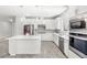 Modern kitchen with white cabinets, stainless steel appliances and kitchen island at 5641 Oak Knoll Dr, St Cloud, FL 34771