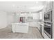 Modern kitchen with white cabinets, stainless steel appliances and kitchen island at 5641 Oak Knoll Dr, St Cloud, FL 34771