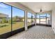 Screened lanai featuring a brick floor and panoramic views of the backyard at 5641 Oak Knoll Dr, St Cloud, FL 34771
