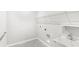 A clean laundry room equipped with sink, utility connections, and wire shelving at 5641 Oak Knoll Dr, St Cloud, FL 34771