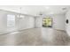 Spacious living room with tile floors, a ceiling fan, and sliding glass doors to the backyard at 5641 Oak Knoll Dr, St Cloud, FL 34771