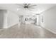Spacious living room and kitchen with gray tile floors and modern ceiling fan at 5641 Oak Knoll Dr, St Cloud, FL 34771